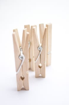 Composition of several wooden pegs on a white background.