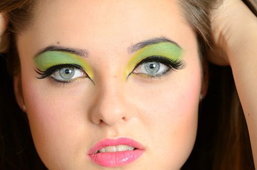 Close face portrait of young female. Polish teenager with colorful makeup.