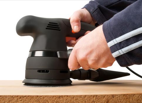 worker with sander machine working on wooden surface