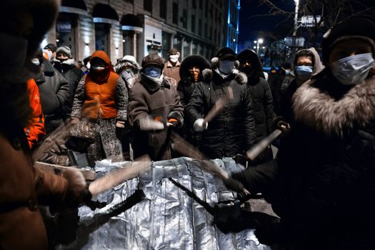 KIEV, UKRAINE - January 20, 2014: Mass anti-government protests in the center of the Ukrainian capital Kiev. People on Hrushevskoho St. preparing to storm by government troops