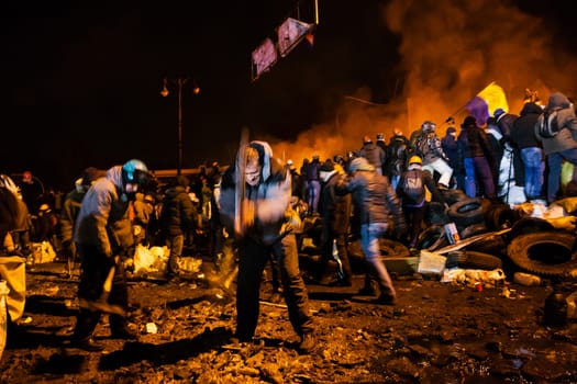 KIEV, UKRAINE - January 24, 2014: Mass anti-government protests in the center of the Ukrainian capital Kiev. Popular Resistance Warrior preparing to storm by government troops  on Hrushevskoho St.
 