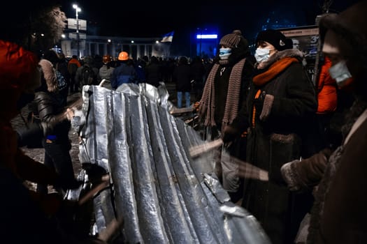 KIEV, UKRAINE - January 20, 2014: Mass anti-government protests in the center of the Ukrainian capital Kiev. People on Hrushevskoho St. preparing to storm by government troops