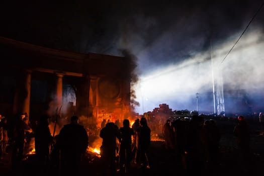 KIEV, UKRAINE - January 24, 2014: Mass anti-government protests in the center of the Ukrainian capital Kiev. Popular Resistance Warrior preparing to storm by government troops  on Hrushevskoho St.
 