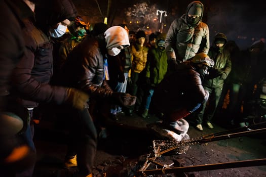 KIEV, UKRAINE - January 24, 2014: Mass anti-government protests in the center of the Ukrainian capital Kiev. Popular Resistance Warrior preparing to storm by government troops   on Hrushevskoho St.
