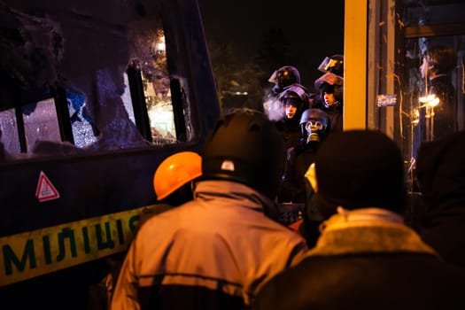 KIEV, UKRAINE - January 24, 2014: Mass anti-government protests in the center of the Ukrainian capital Kiev. Negotiations between resistance fighters and police  on Hrushevskoho St.
 