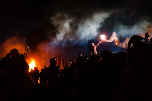 KIEV, UKRAINE - January 24, 2014: Mass anti-government protests in the center of the Ukrainian capital Kiev. Popular Resistance Warrior preparing to storm by government troops  on Hrushevskoho St.
 