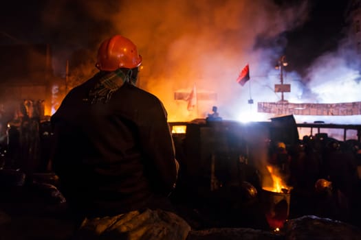 KIEV, UKRAINE - January 24, 2014: Mass anti-government protests in the center of the Ukrainian capital Kiev. Popular Resistance Warrior preparing to storm by government troops  on Hrushevskoho St.
 