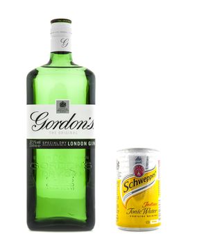 SWINDON, UK - JANUARY 1, 2014:  Gin And Tonic. Original Gordon's London Dry Gin bottle and Can of Schweppes Tonic Water on withe background