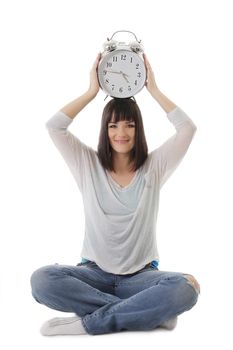 Smiling girl with clock on head in lotus pose over white
