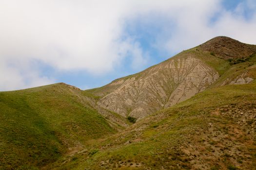 Treeless small mountain with green grass in Crimea
