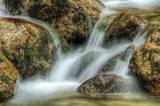 Nice detail of small cascade with mossy stones 