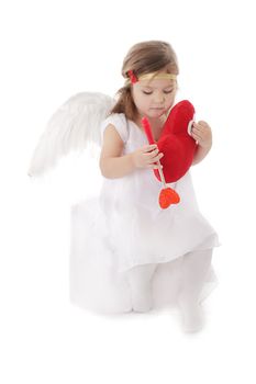 Sad cupid girl sitting with heart over white