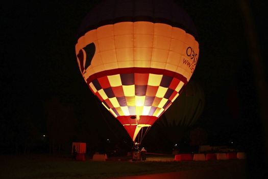 Hot air baloon starting to fly in the evening sky