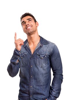 Portrait of a smiling young man pointing up