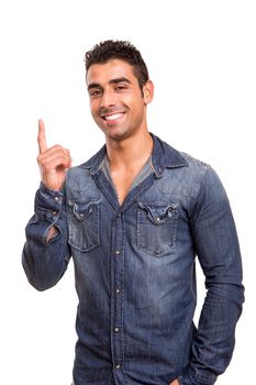 Portrait of a smiling young man pointing up