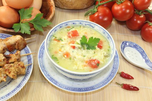 Asian Chicken soup with eggs, noodles and greens