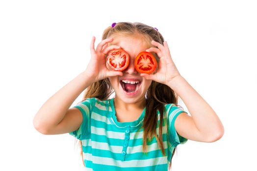 little smiling girl with tomatoes near the eye