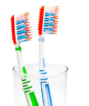 two toothbrushes in a glass isolated on a white background