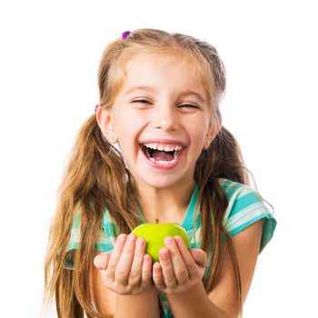 little girl laughing and holding an apple isolated on white background