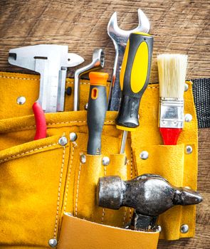 set of tools in a bag on wooden background