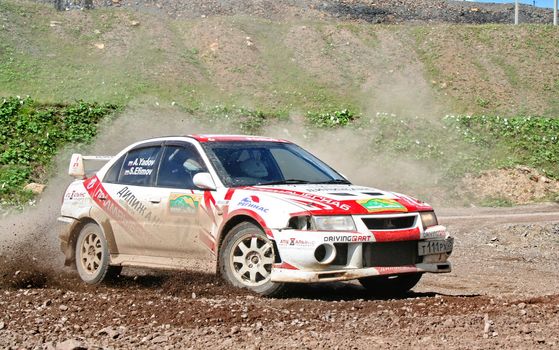 BAKAL, RUSSIA - AUGUST 8: Andrey Yadov's Mitsubishi Lancer Evolution (No. 12) competes at the annual Rally Southern Ural on August 8, 2008 in Bakal, Satka district, Chelyabinsk region, Russia.