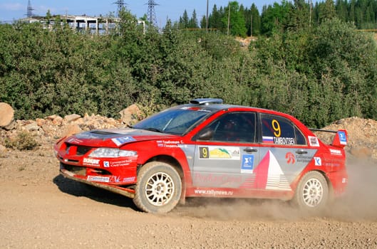 BAKAL, RUSSIA - AUGUST 13: Sergey Tambovtsev's Mitsubishi Lancer Evo VIII (No. 9) competes at the annual Rally Southern Ural on August 13, 2010 in Bakal, Satka district, Chelyabinsk region, Russia.