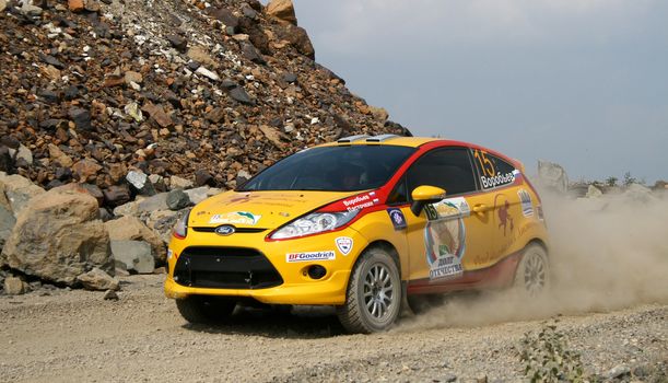 BAKAL, RUSSIA - AUGUST 13: Sergey Lastochkin's FORD Fiesta (No. 15) competes at the annual Rally Southern Ural on August 13, 2010 in Bakal, Satka district, Chelyabinsk region, Russia.