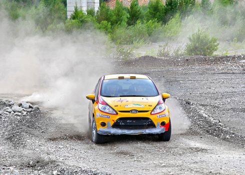 BAKAL, RUSSIA - JULY 21: Ivan Vorobyov's Ford Fiesta (No. 15) competes at the annual Rally Southern Ural on July 21, 2012 in Bakal, Satka district, Chelyabinsk region, Russia.