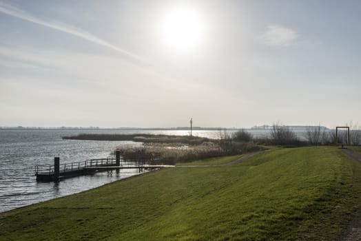 sunshine over dutch ijsselmeer lake in the north of holland
