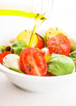 Fresh salad with tomatoes, mozzarella and olive oil