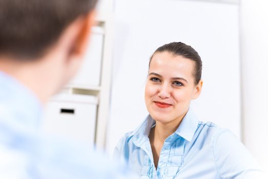 business woman holding an interview with a man in the office