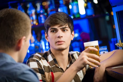 portrait of a young man at the bar, fun nightlife