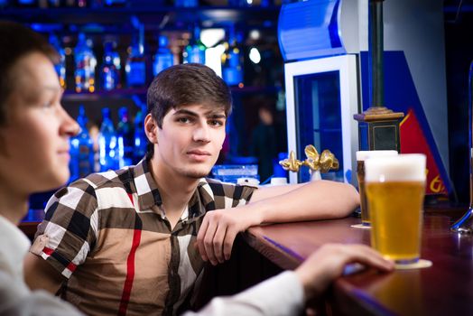 portrait of a young man at the bar, spending time in a nightclub