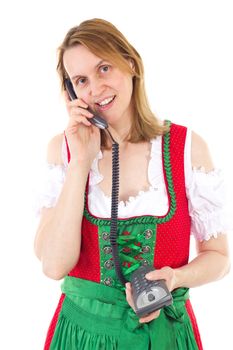 Woman in red dirndl dialing a friend