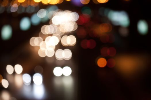 Road at night with traffic trails and blurred lights