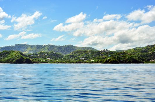 Beautiful paradise, out on the ocean looking at tropical island with jungle