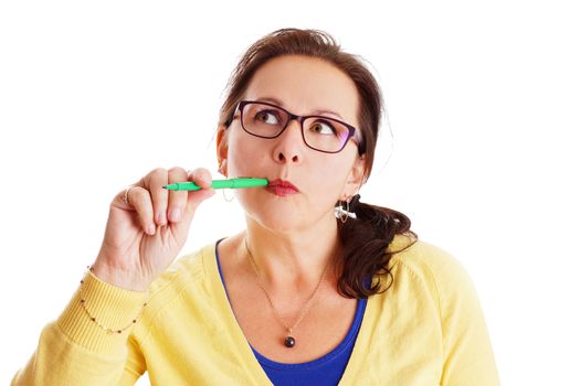 Funny woman thinking hard, dressed in colorful yellow, blue with green pen