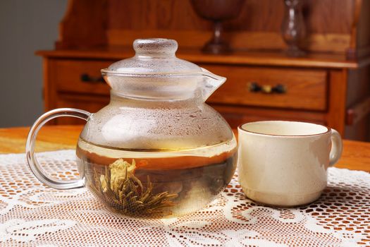 Blossom tea in glass teapot with cup, vintage look