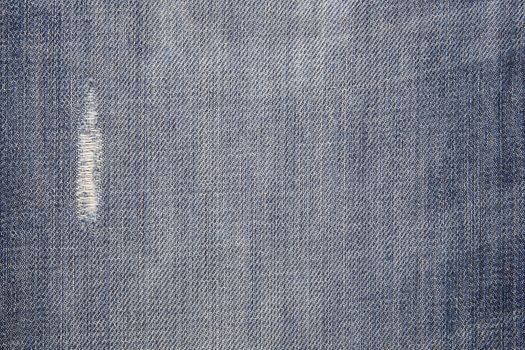 The worn, blue jeans, a textile background