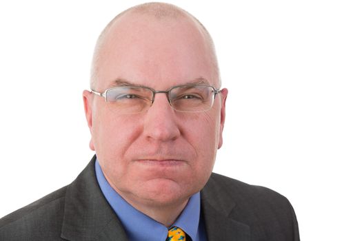 Portrait of an angry revengeful Caucasian middle-aged bald businessman wearing glasses and formal business suit looking at camera with a malicious facial expression, isolated on white background