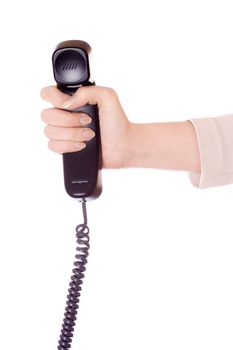 Hand holding a black telephone handset over a white background.