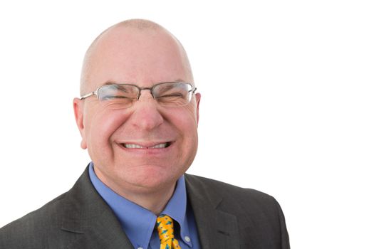 Disdainful businessman grimacing in disgust wrinkling up his nose to show his displeasure, head and shoulders portrait on white