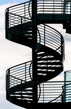 Spiral staircase and sky background