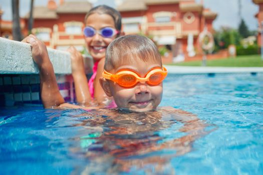 Activities on the pool. Cute boy in swimming pool