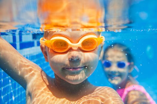 Close-up underwater portrait of the cute smiling boy