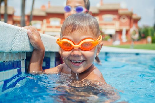 Activities on the pool. Cute boy in swimming pool