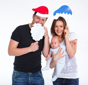 Christmas theme - Portrait of happy family with baby in Santa's hat, isolated on white.