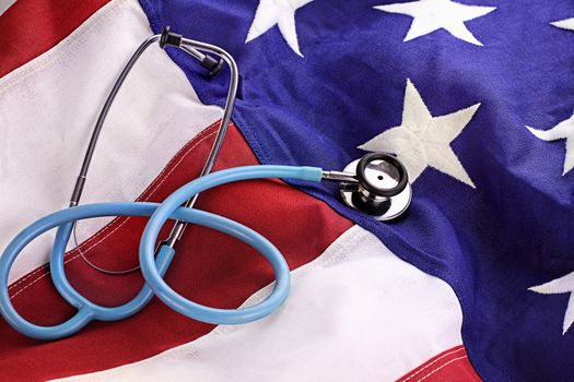 Stethoscope placed over American flag and credit card. 