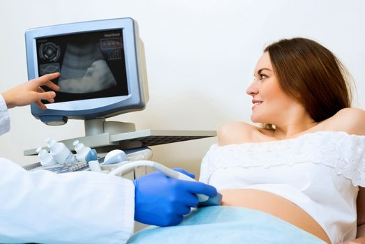 young pregnant woman on the ultrasound, health check