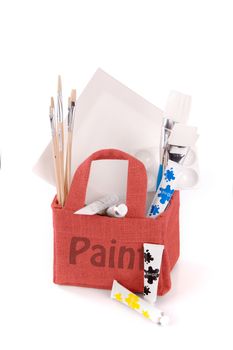 a red bag with drawing and painting equipment on a white background